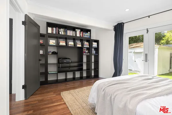 a bedroom with a bed a window and closet