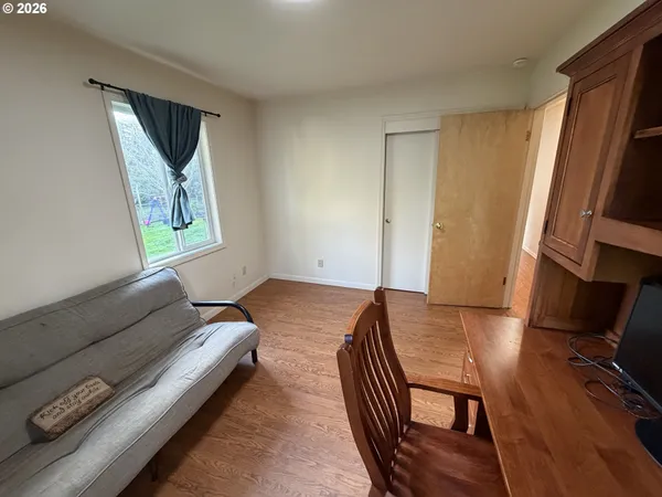 a bedroom with furniture and a window