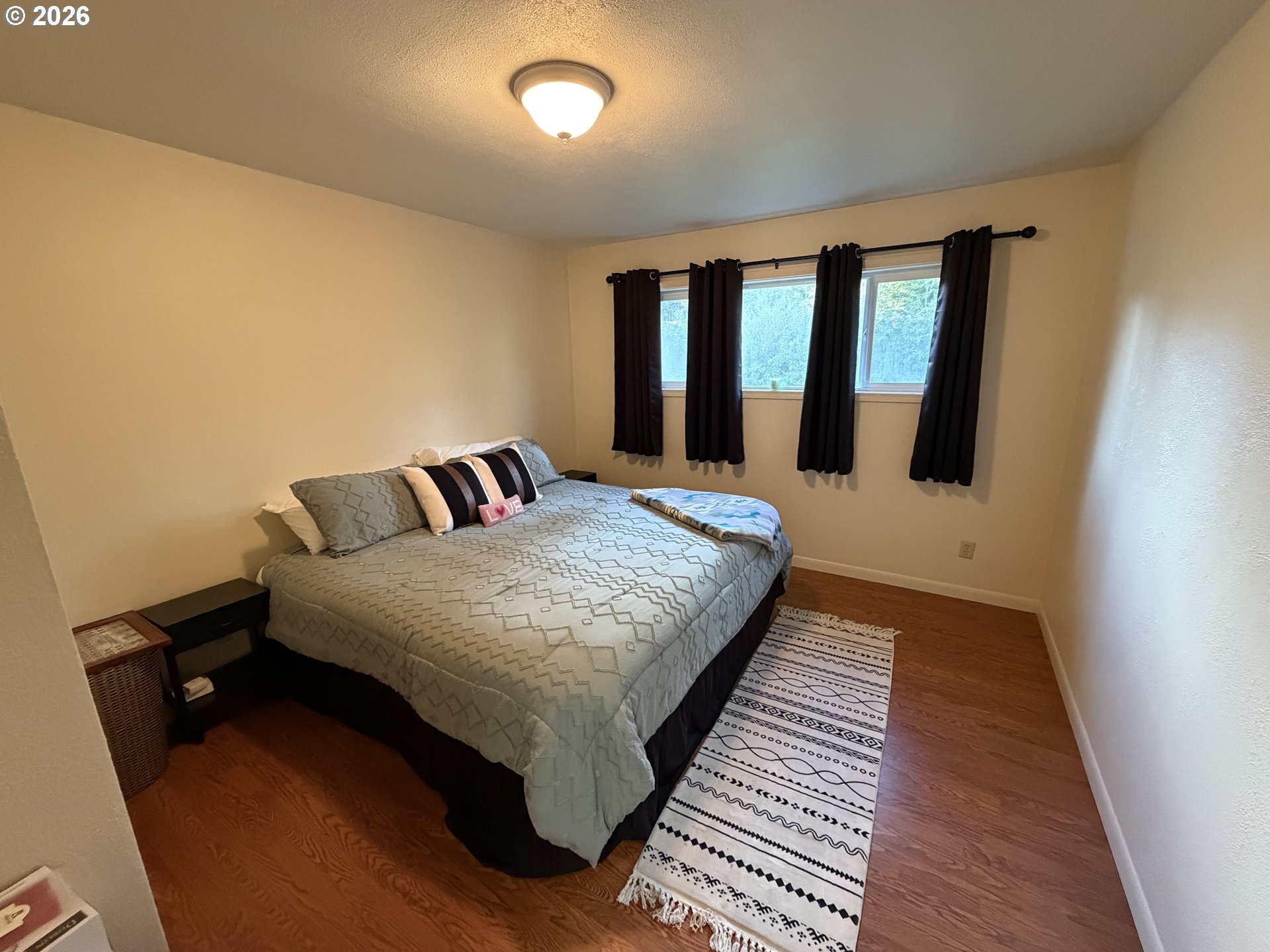92738 Knapp Road Port Orford, OR 97465 - Photo 13 of 34 a bedroom with a bed and wooden floor