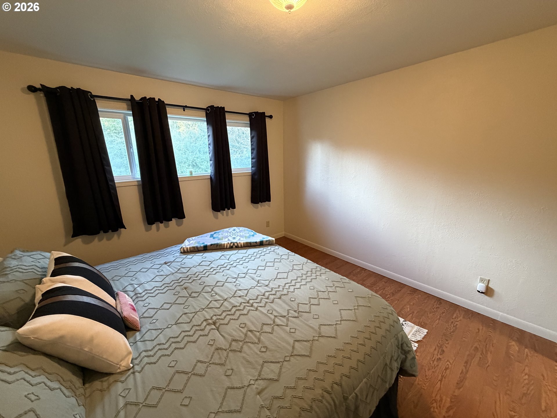 92738 Knapp Road Port Orford, OR 97465 - Photo 14 of 34 a bedroom with a bed and mirror