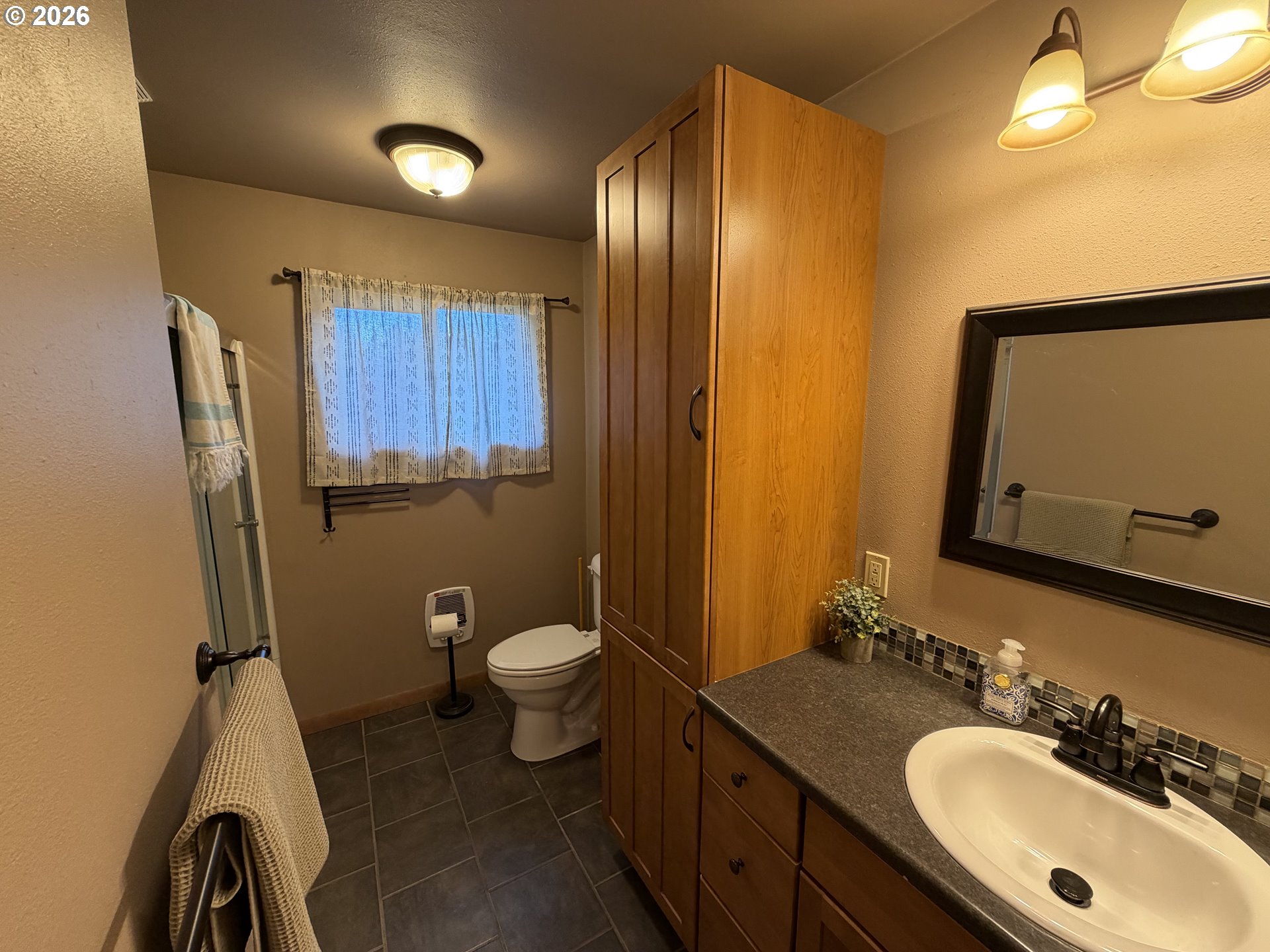 92738 Knapp Road Port Orford, OR 97465 - Photo 16 of 34 a bathroom with a sink a toilet and mirror