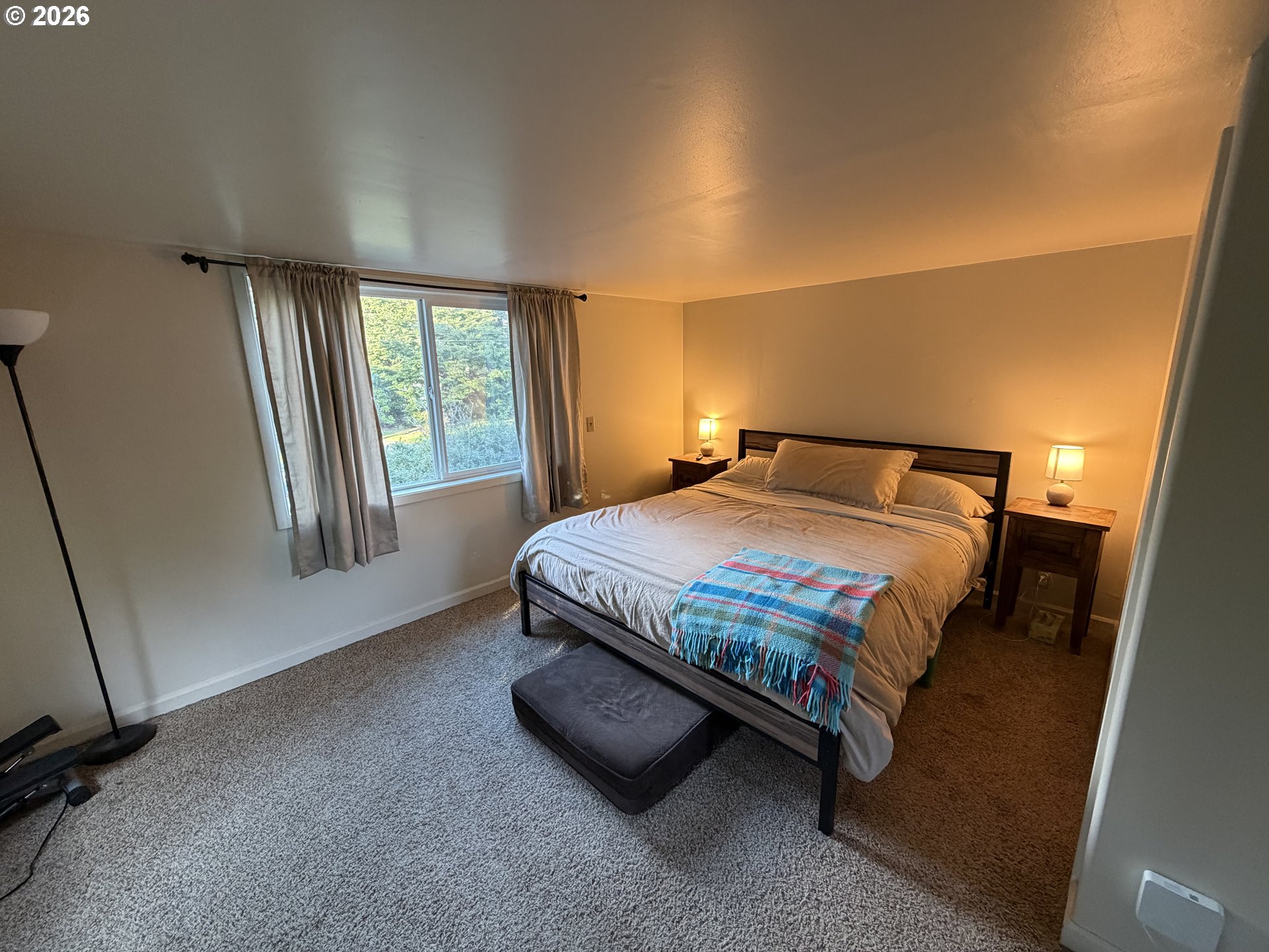 92738 Knapp Road Port Orford, OR 97465 - Photo 20 of 34 a bedroom with a bed and a window