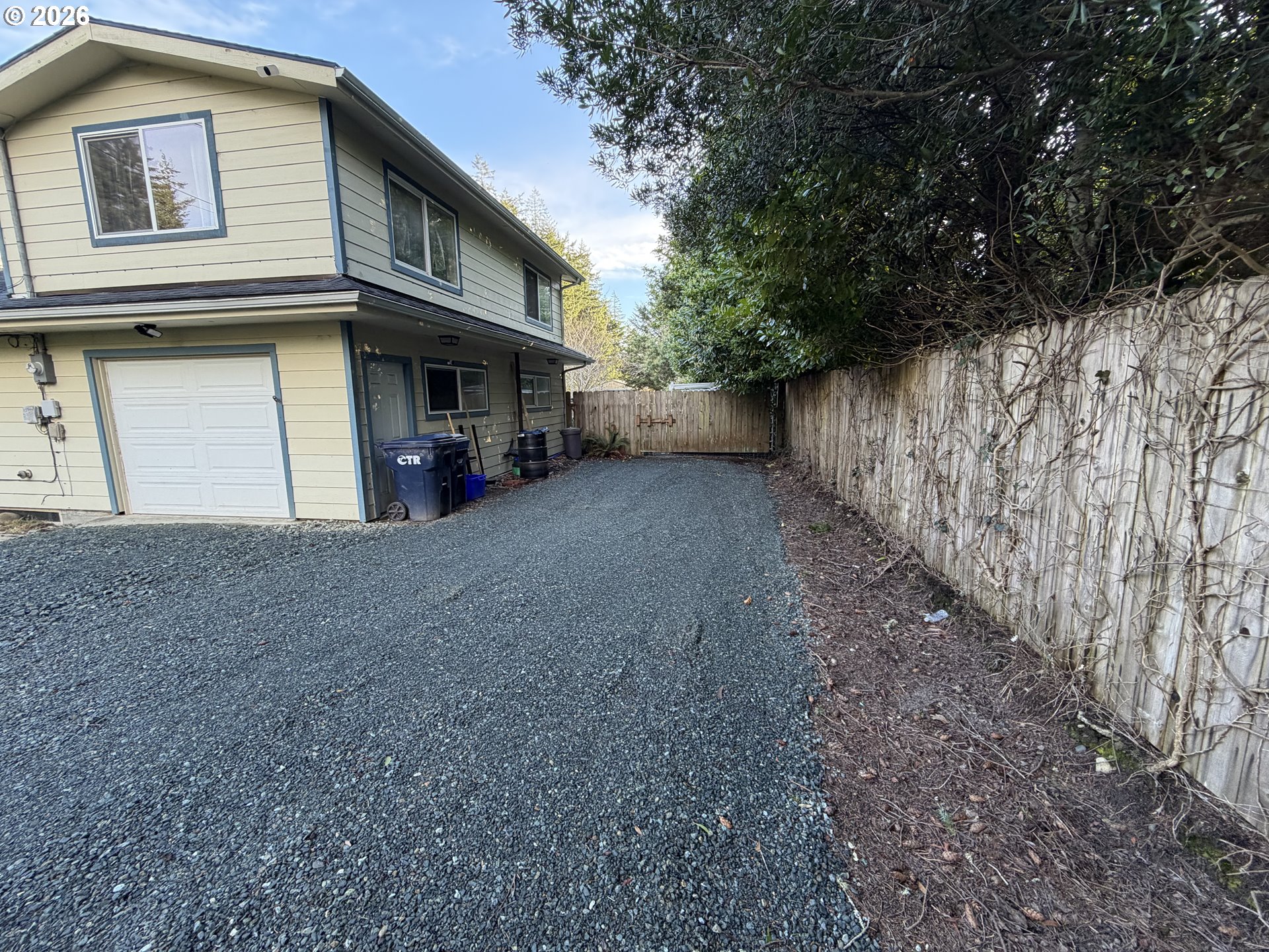 92738 Knapp Road Port Orford, OR 97465 - Photo 2 of 34 a view of a house with a tree and wooden fence
