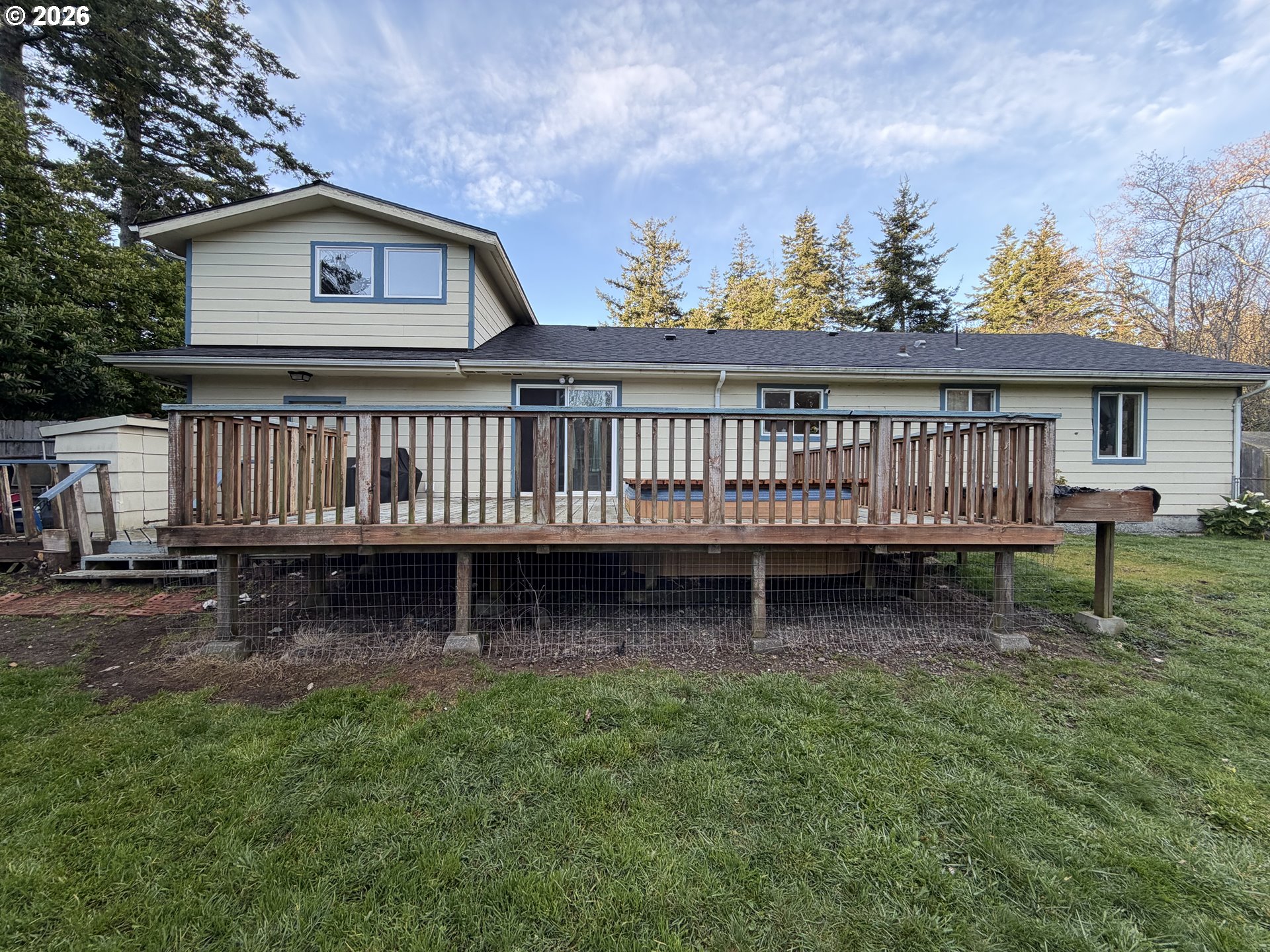 92738 Knapp Road Port Orford, OR 97465 - Photo 23 of 34 a view of backyard with a wooden deck and furniture