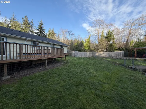 a view of a house with a backyard and a garden