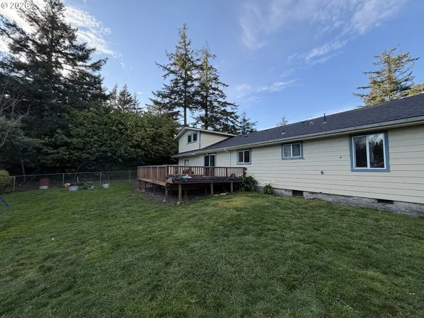 a view of a backyard with plants and a garden