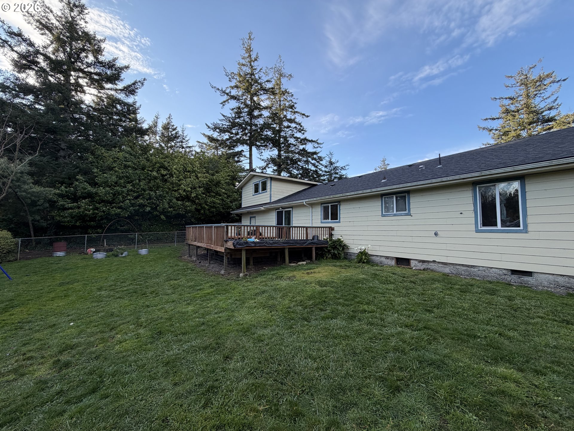 92738 Knapp Road Port Orford, OR 97465 - Photo 25 of 34 a view of a backyard with plants and a garden