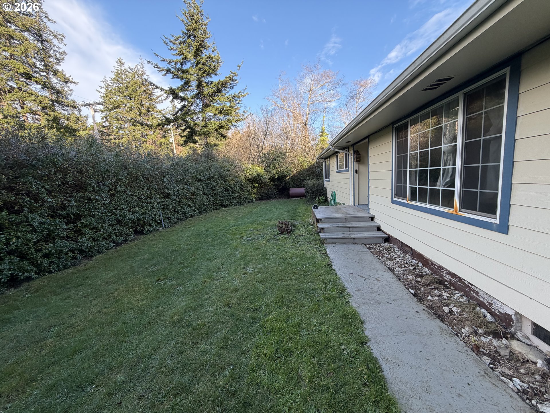 92738 Knapp Road Port Orford, OR 97465 - Photo 3 of 34 a front view of a house with garden