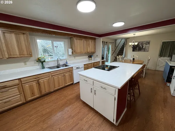 a kitchen that has a sink and a stove in it