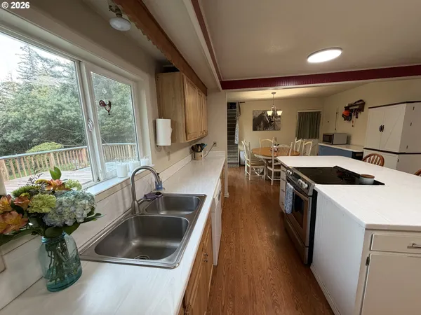 a kitchen filled a sink a counter top space and living room