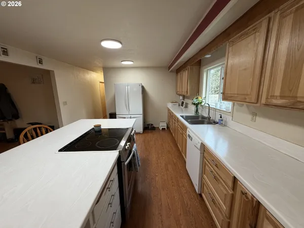 a kitchen with a sink and wooden cabinets