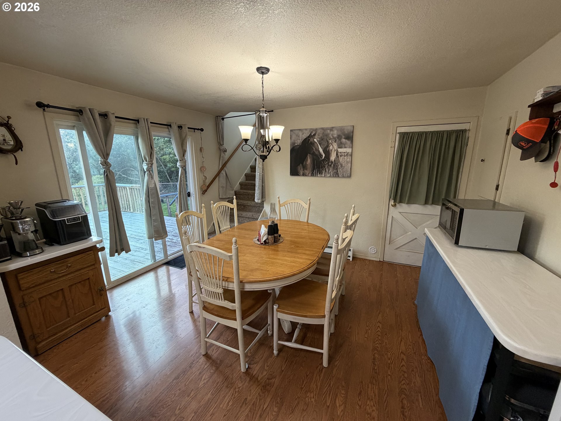 92738 Knapp Road Port Orford, OR 97465 - Photo 9 of 34 a view of a dining room with furniture and wooden floor