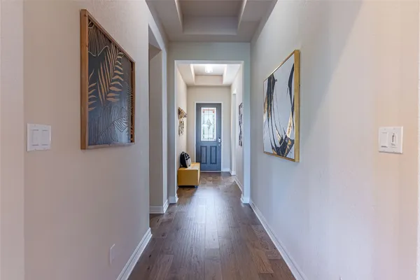 a view of a hallway with wooden floor