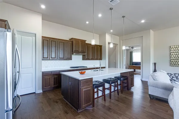 a large kitchen with a table and chairs
