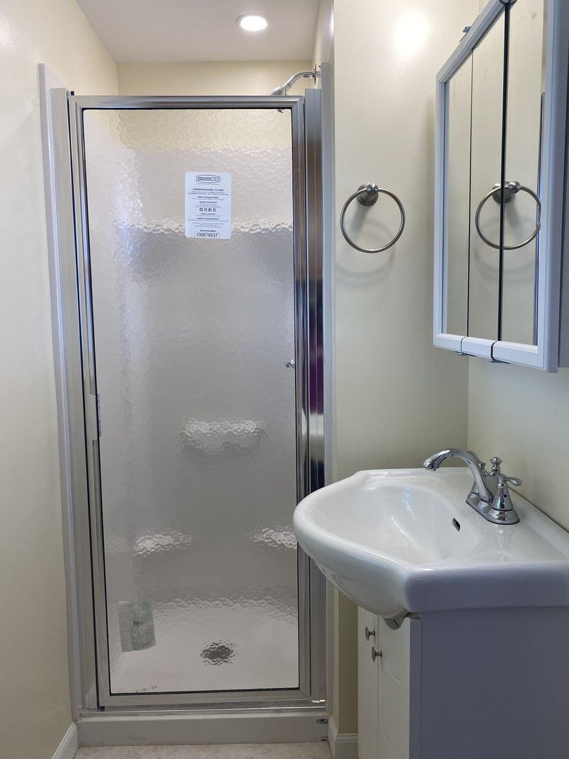 18240 Hurd Road Prophetstown, IL 61277 - Photo 12 of 18 a bathroom with a shower and a sink