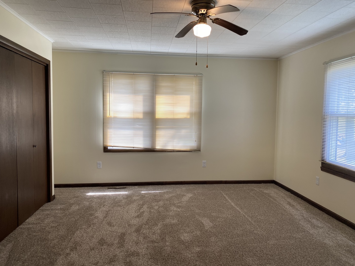 18240 Hurd Road Prophetstown, IL 61277 - Photo 8 of 18 an empty room with a window and a ceiling fan