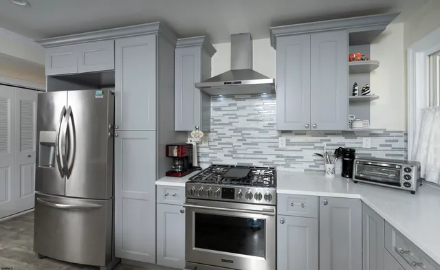 a kitchen with kitchen island a table and chairs