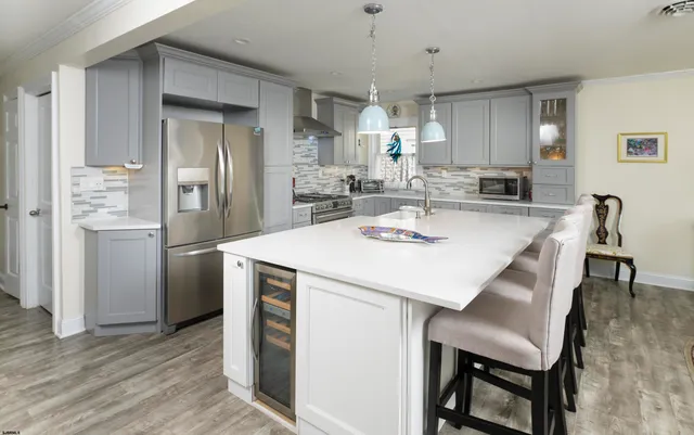 a kitchen with a refrigerator a sink and cabinets