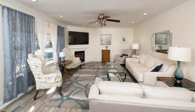 a living room with furniture a flat screen tv and a fireplace