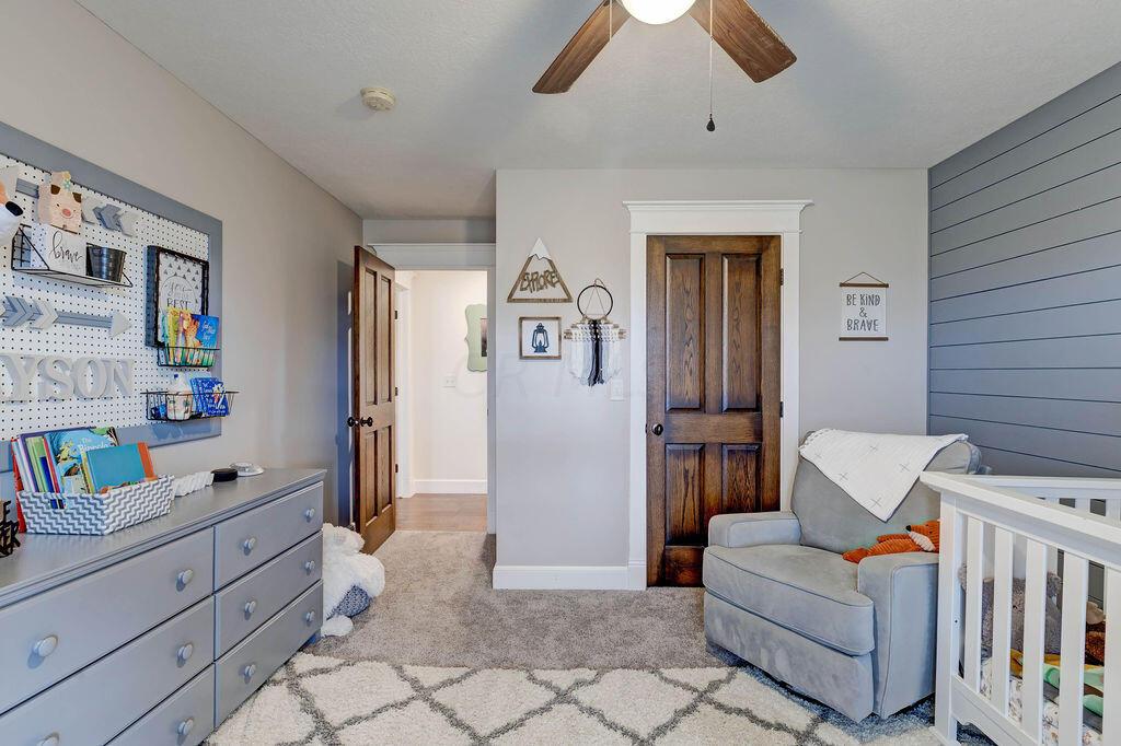 4045 Russell Road Mount Gilead, OH 43338 - Photo 29 of 74 • New gray carpet • Tan painted walls & gray shiplap wall • Walk-in closet • Lighted ceiling fan