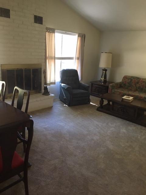 16235 Valley Ranch Road Santa Clarita, CA 91387 - Photo 16 of 24 a living room with furniture and a fireplace