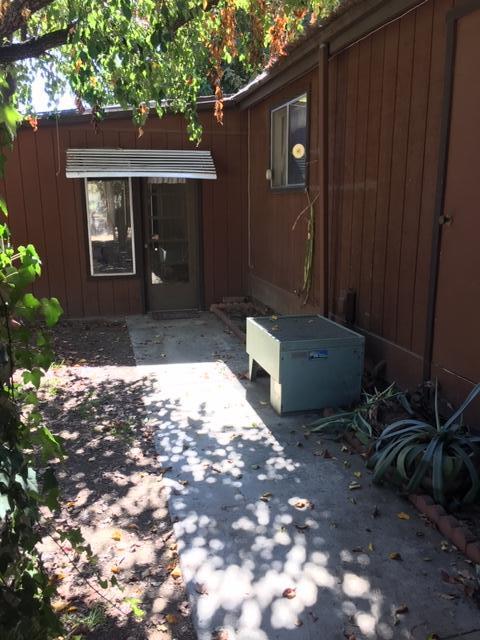 16235 Valley Ranch Road Santa Clarita, CA 91387 - Photo 20 of 24 a backyard of a house with barbeque oven and outdoor seating