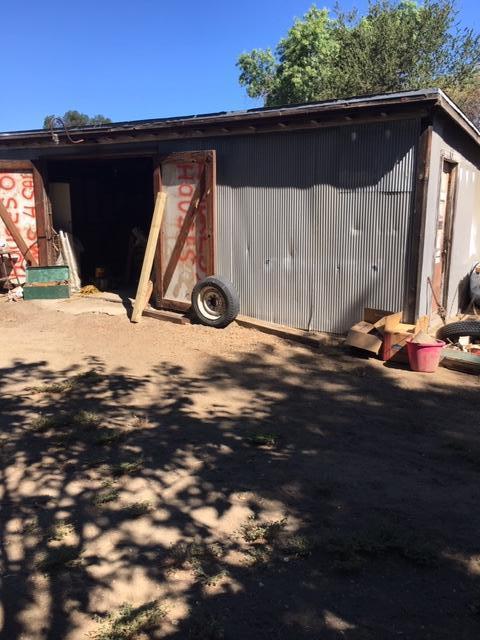 16235 Valley Ranch Road Santa Clarita, CA 91387 - Photo 21 of 24 a backyard of a house with table and chairs