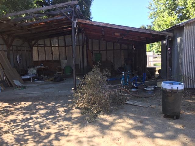 16235 Valley Ranch Road Santa Clarita, CA 91387 - Photo 22 of 24 a view of a backyard with table and chairs and a large tree