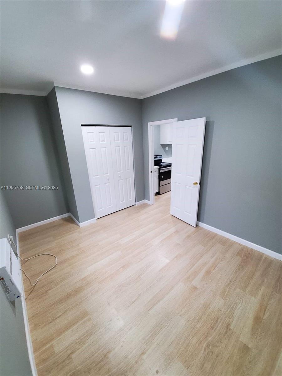 2425 Northwest 28th Street Miami, FL 33142 - Photo 11 of 18 a view of empty room with wooden floor