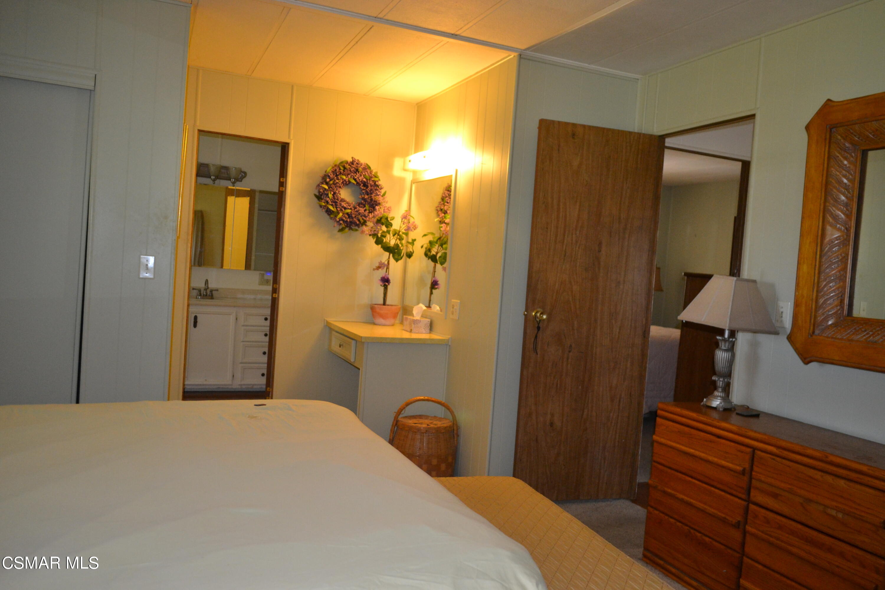 6480 Katherine Road, Unit 44 Simi Valley, CA 93063 - Photo 14 of 32 a bedroom with a bed and a lamp on dresser