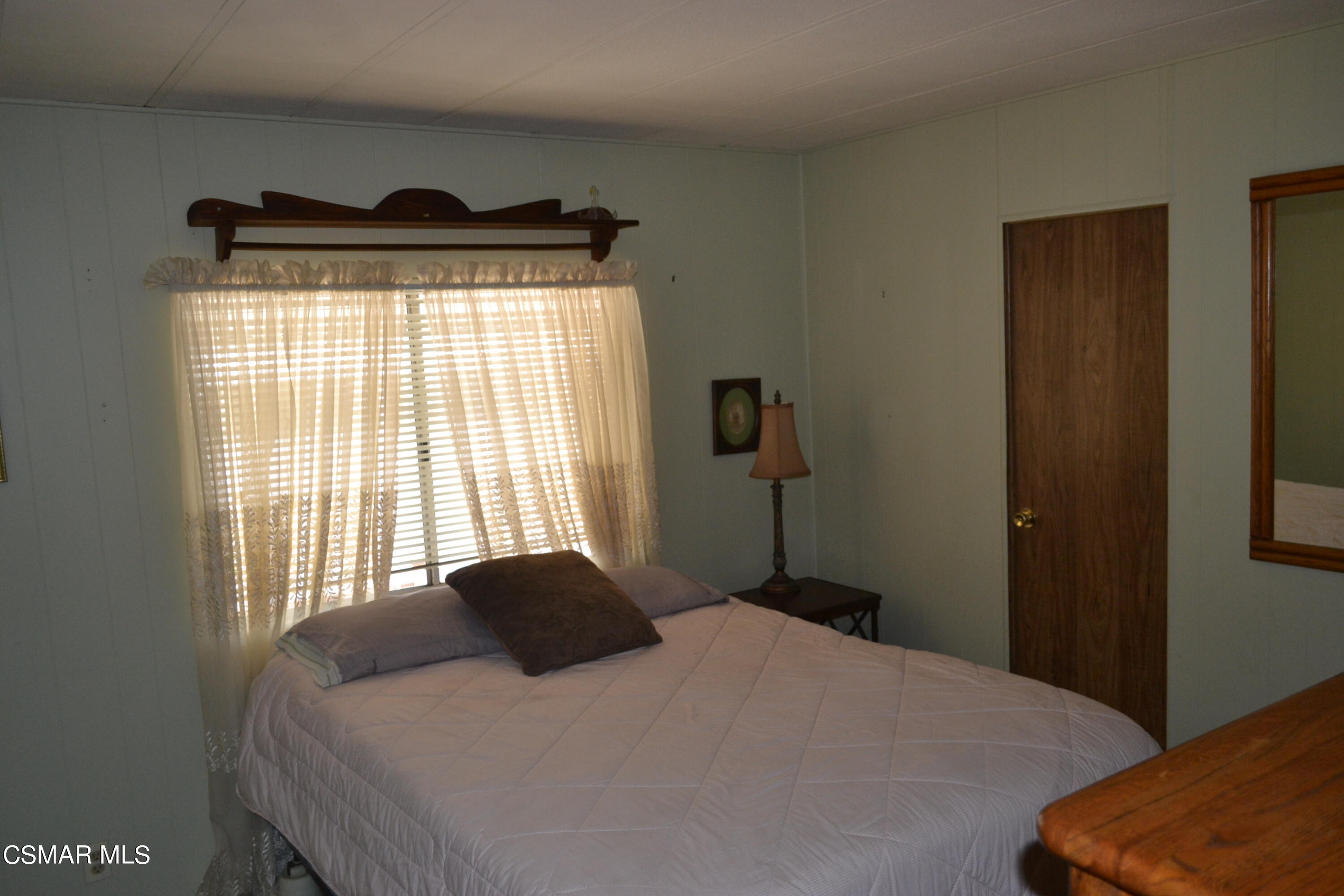 6480 Katherine Road, Unit 44 Simi Valley, CA 93063 - Photo 15 of 32 a bedroom with a bed and a window