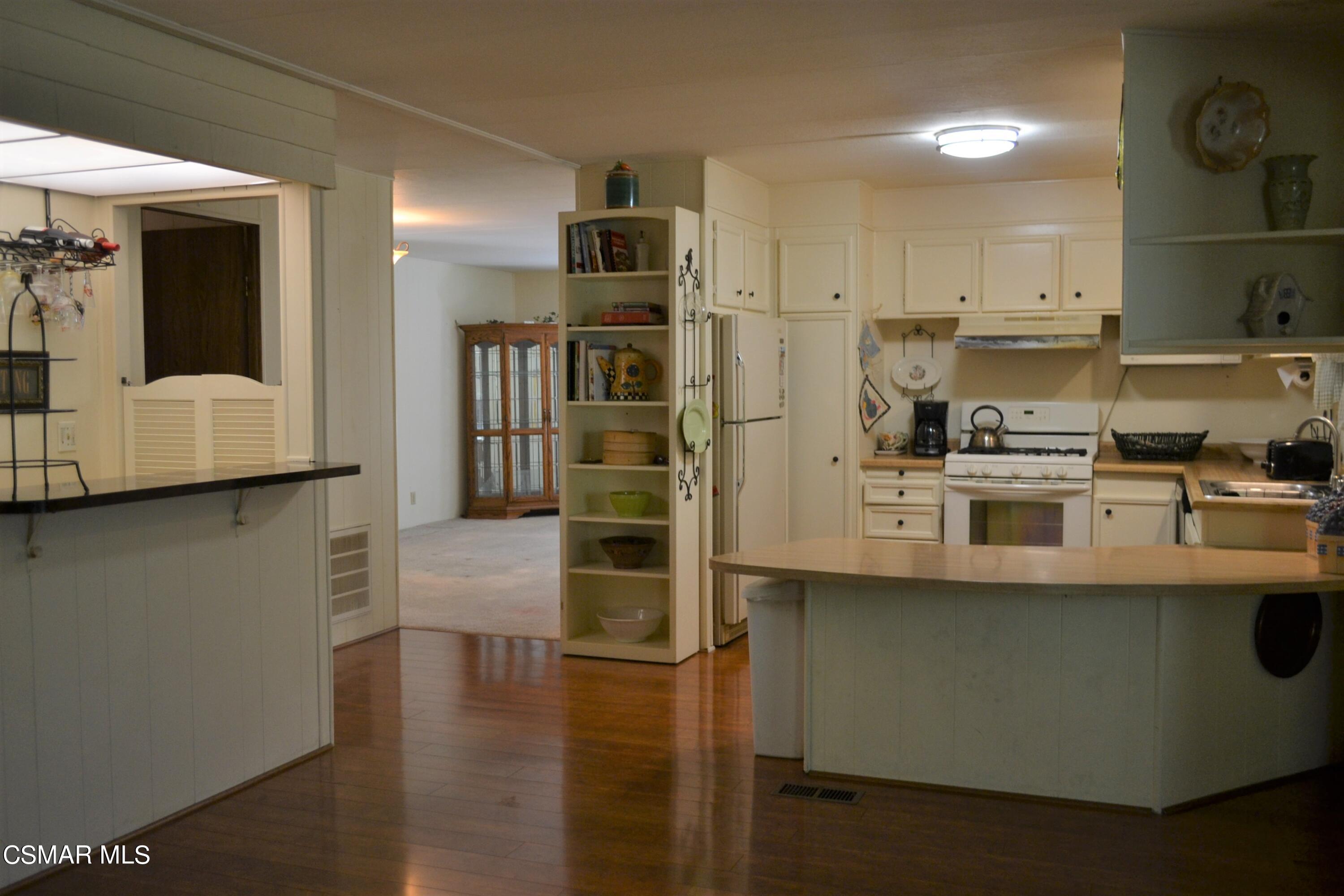 6480 Katherine Road, Unit 44 Simi Valley, CA 93063 - Photo 5 of 32 a kitchen with stainless steel appliances a refrigerator and a stove top oven