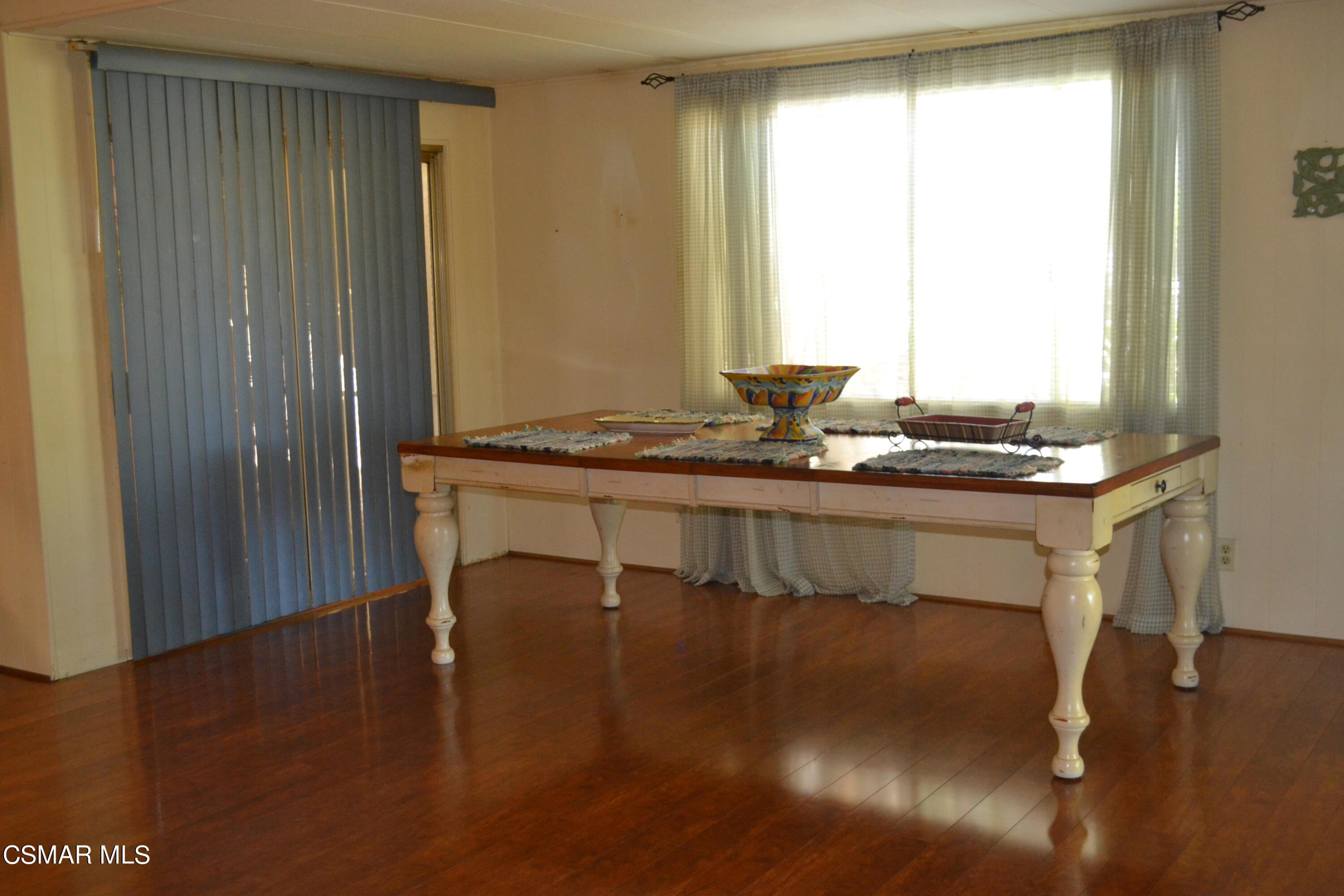 6480 Katherine Road, Unit 44 Simi Valley, CA 93063 - Photo 6 of 32 a dining room with furniture window and wooden floor
