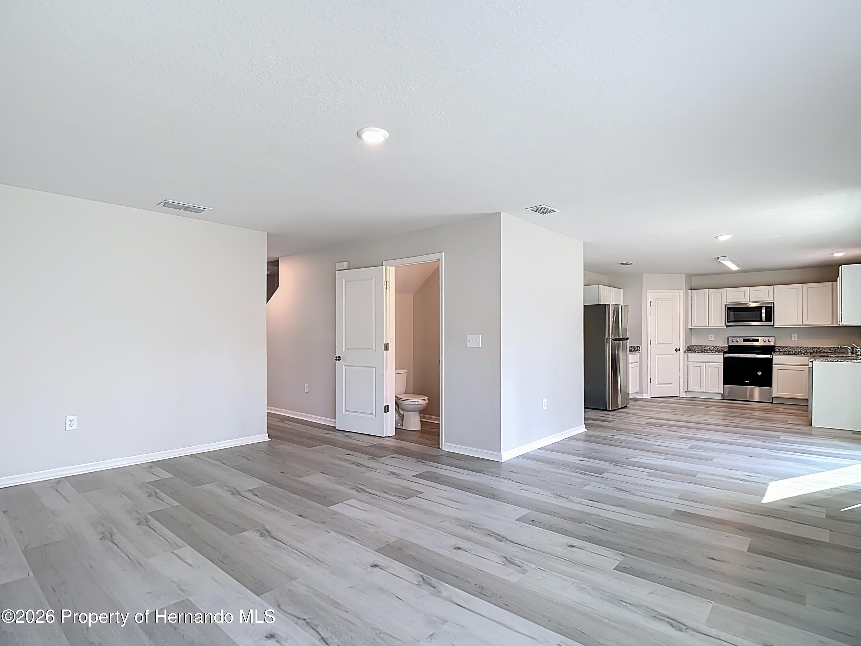 11374 Marcella Avenue Weeki Wachee, FL 34614 - Photo 18 of 70 a view of kitchen living room with wooden floor