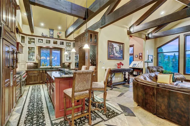 a living room with fireplace furniture and a large window