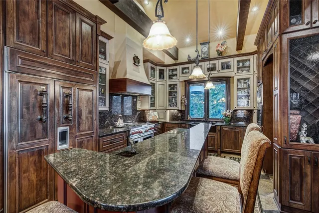 a kitchen with stainless steel appliances granite countertop a stove and a refrigerator