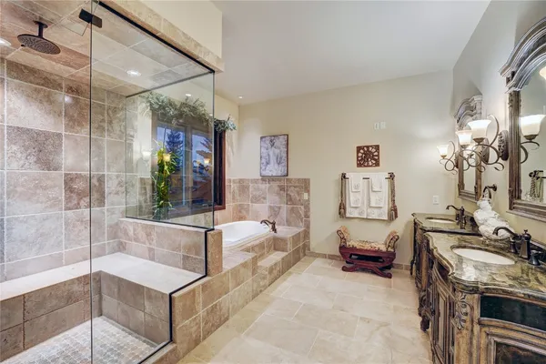 a bathroom with a granite countertop tub shower and sink
