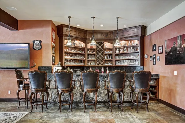 a bathroom with a granite countertop toilet sink and mirror