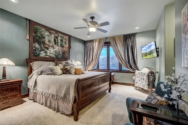 a bedroom with a large bed and dresser