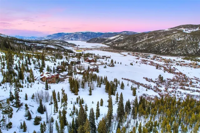 a front view of a house with a garden and chairs