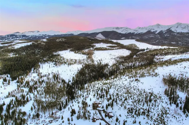 a view of a cafe with a table and chairs under an umbrella