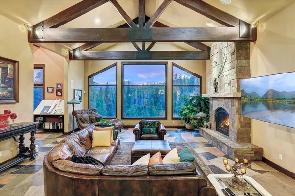 a living room with fireplace furniture and a fireplace