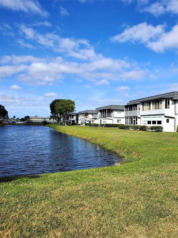 357 Saxony Lane, Unit 357 Delray Beach, FL 33446 - Photo 18 of 35 a view of swimming pool with outdoor seating and garden
