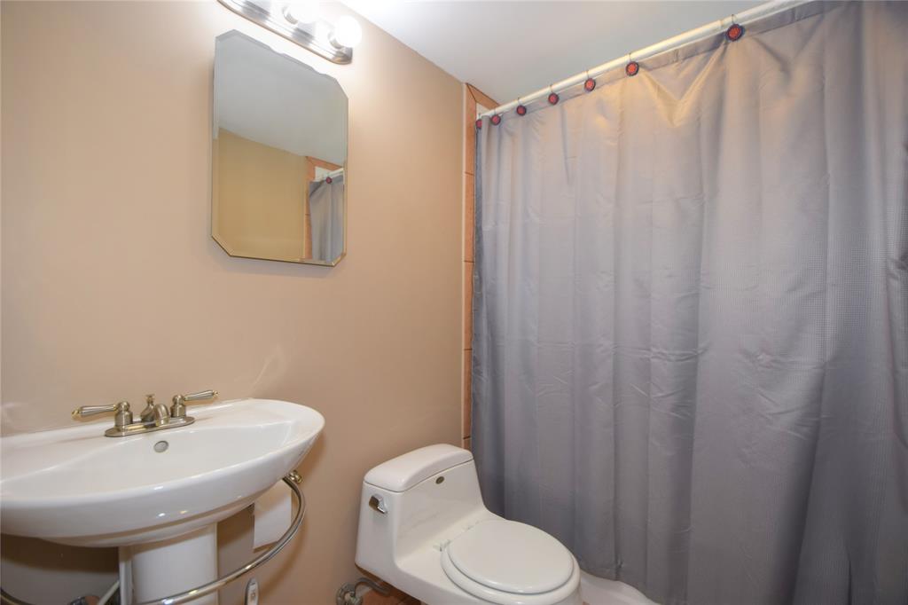 357 Saxony Lane, Unit 357 Delray Beach, FL 33446 - Photo 10 of 35 a bathroom with a sink a toilet and mirror