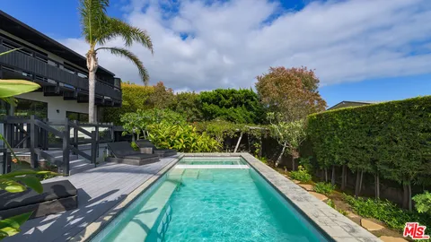 a backyard of a house with barbeque oven table and chairs