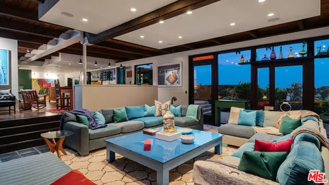 a roof deck with couch and chairs