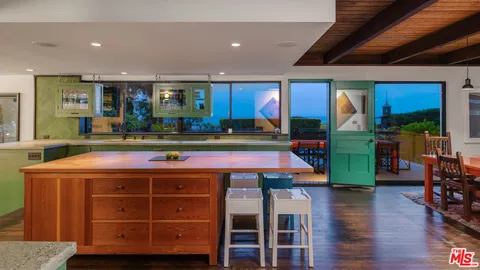 a view of balcony with wooden floor and floor to ceiling window