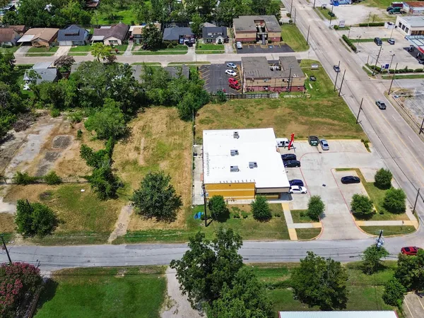 an aerial view of multiple houses with yard