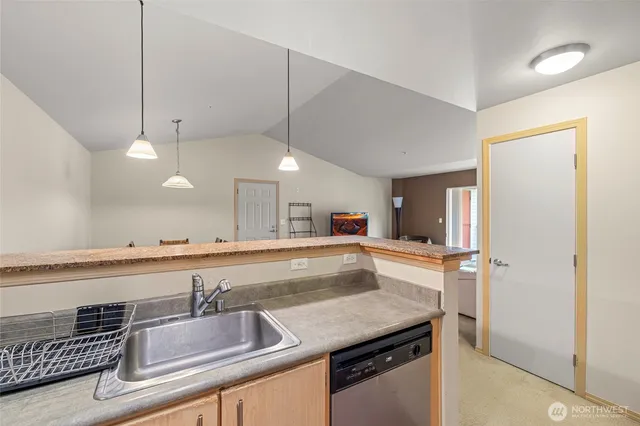 a kitchen with granite countertop a sink and center island