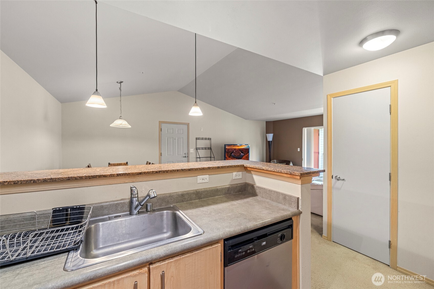 10709 Valley View Road, Unit B403 Bothell, WA 98011 - Photo 16 of 32 a kitchen with granite countertop a sink and center island